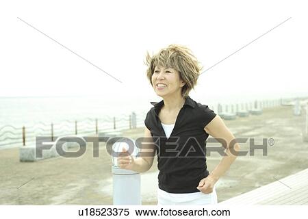 Mature woman jogging on beach, smiling View Large Photo Image Stock Photography - Mature woman jogging on beach, smiling. Fotosearch