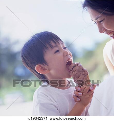 Mother and son eating ice cream View Large Photo Image Stock Image - Mother and son eating ice cream. Fotosearch