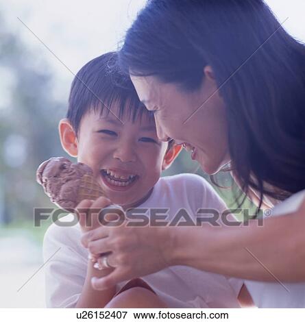 Stock Photo - Mother and son holding ice cream. Fotosearch
