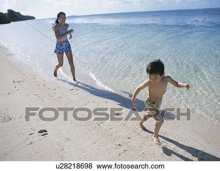 Mother and son running on beach View Large Photo Image Stock Photo - Mother and son running on beach. Fotosearch