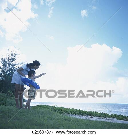 Mother and son standing on beach View Large Photo Image Stock Photo - Mother and son standing on beach. Fotosearch