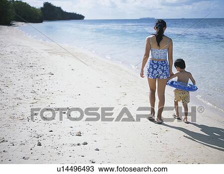 Mother and son walking on beach View Large Photo Image Stock Image - Mother and son walking on beach. Fotosearch