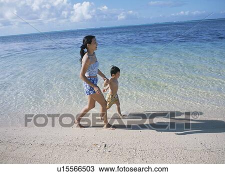 Mother and son walking on beach View Large Photo Image Stock Image - Mother and son walking on beach. Fotosearch