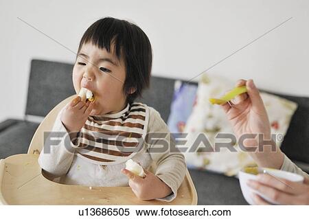 Mother feeding baby boy View Large Photo Image Stock Photography - Mother feeding baby boy. Fotosearch