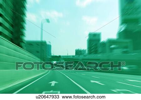 Stock Image - Office buildings and highway, toned image, blurred motion, Tokyo prefecture, Japan. Fotosearch