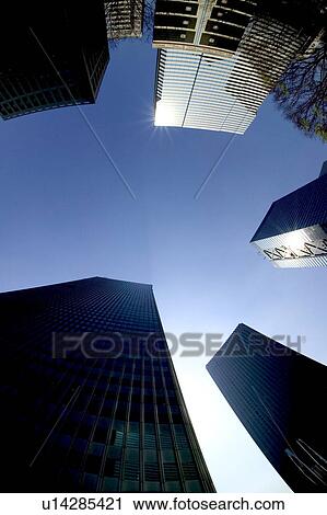 Stock Image - Office buildings under blue sky, fish-eye lens, Tokyo prefecture, Japan. Fotosearch