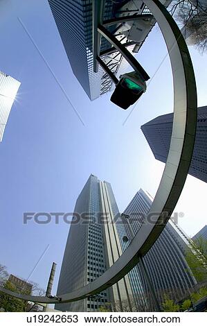 Stock Image - Office buildings under blue sky, fish-eye lens, Tokyo prefecture, Japan. Fotosearch