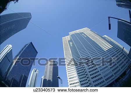 Stock Image - Office buildings under blue sky, fish-eye lens, Tokyo prefecture, Japan. Fotosearch