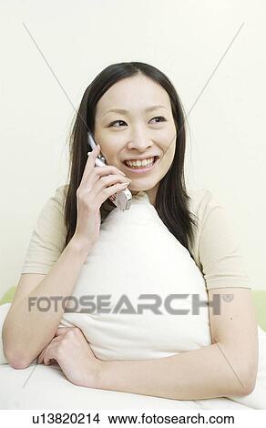 Picture - One young woman on cell phone. Fotosearch