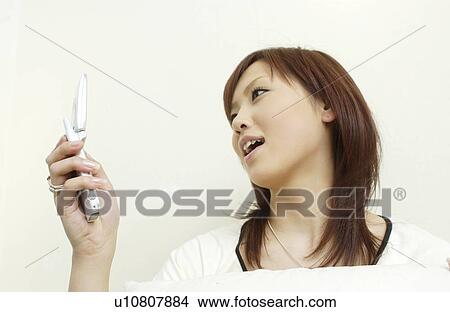 One young woman text messaging View Large Photo Image Picture - One young woman text messaging. Fotosearch