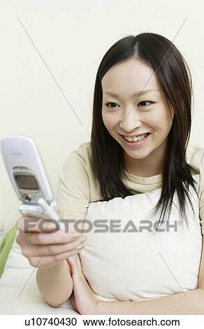 One young woman text messaging View Large Photo Image Stock Image - One young woman text messaging. Fotosearch