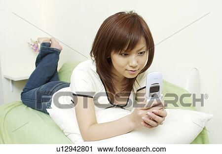 One young woman text messaging View Large Photo Image Stock Image - One young woman text messaging. Fotosearch