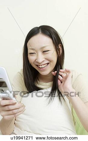 One young woman text messaging View Large Photo Image Stock Image - One young woman text messaging. Fotosearch