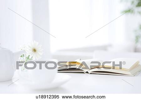 Stock Photography - Opened book and coffee setting, white background. Fotosearch