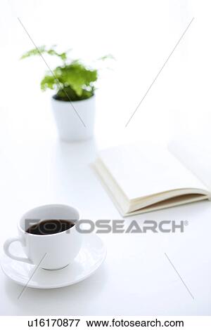 Opened book and cup of coffee on table, white background View Large Photo Image Stock Photo - Opened book and cup of coffee on table, white background. Fotosearch