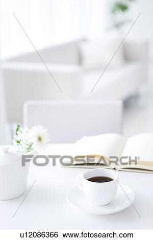 Opened book and cup of coffee on table View Large Photo Image Stock Photograph - Opened book and cup of coffee on table. Fotosearch