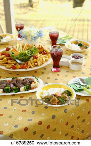 Stock Image - Party dishes on dining table. Fotosearch