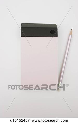 Pencil and note pad on white background View Large Photo Image Stock Photo - Pencil and note pad on white background. Fotosearch