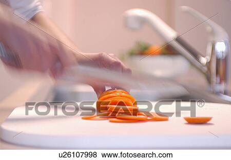 Person slicing carrots View Large Photo Image Stock Photo - Person slicing carrots. Fotosearch