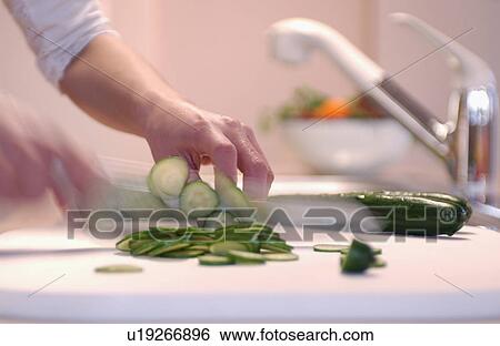 Person slicing cucumber View Large Photo Image Stock Photograph - Person slicing cucumber. Fotosearch