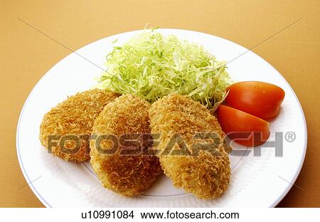 Picture - Plate of fried croquettes, colored background. Fotosearch