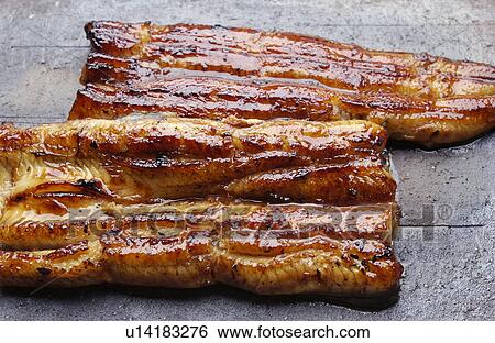 Stock Photograph - Plate of grilled eel, close up. Fotosearch
