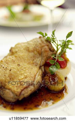 Stock Photo - Plate of roasted chicken, close up. Fotosearch