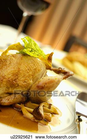 Stock Image - Plate of roasted quail, close up. Fotosearch
