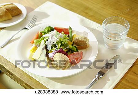 Plate of salad on table View Large Photo Image Stock Photo - Plate of salad on table. Fotosearch