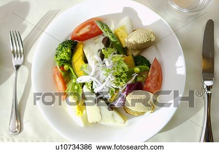 Plate of salad on table View Large Photo Image Stock Photograph - Plate of salad on table. Fotosearch