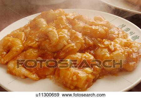 Stock Photo - Plate of shrimps with chili sauce, close up. Fotosearch