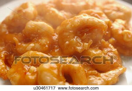 Stock Photo - Plate of shrimps with chili sauce, close up. Fotosearch