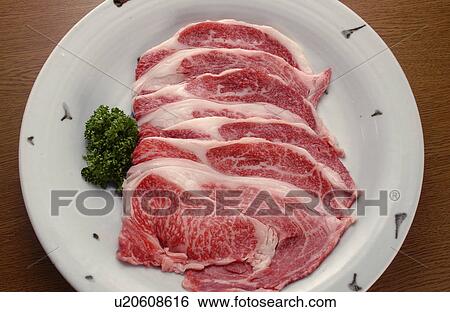 Stock Photograph - Plate of sliced raw beef. Fotosearch