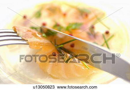 Stock Image - Plate of sliced raw fish, close up. Fotosearch