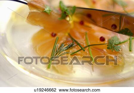 Stock Image - Plate of sliced raw fish, close up. Fotosearch