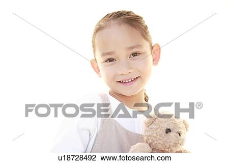 Portrait of a girl holding stuffed animal View Large Photo Image Stock Image - Portrait of a girl holding stuffed animal. Fotosearch