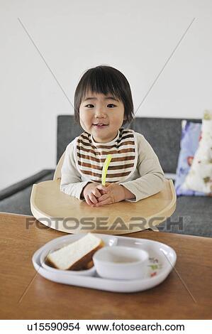 Portrait of baby boy sitting in high chair, smiling View Large Photo Image Picture - Portrait of baby boy sitting in high chair, smiling. Fotosearch