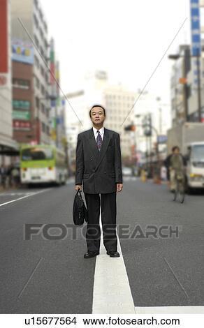 Portrait of businessman standing at street, Tokyo prefecture, Japan View Large Photo Image Picture - Portrait of businessman standing at street, Tokyo prefecture, Japan. Fotosearch