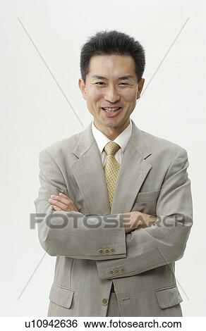 Portrait of businessman with arms crossed, smiling, white background View Large Photo Image Stock Photograph - Portrait of businessman with arms crossed, smiling, white background. Fotosearch