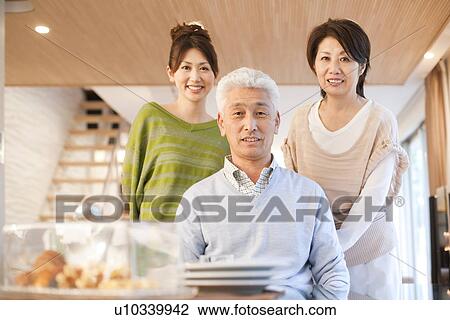 Portrait of family in dining room, smiling View Large Photo Image Stock Image - Portrait of family in dining room, smiling. Fotosearch