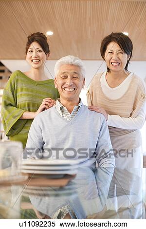 Portrait of family in dining room, smiling View Large Photo Image Stock Photography - Portrait of family in dining room, smiling. Fotosearch