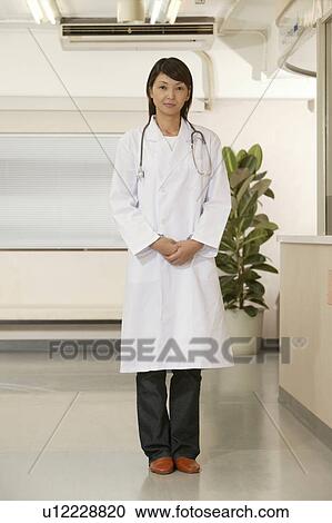 Stock Image - Portrait of female doctor, smiling. Fotosearch