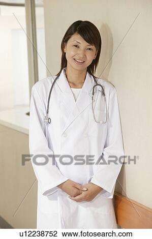 Stock Image - Portrait of female doctor, smiling. Fotosearch