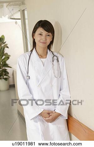 Portrait of female doctor, smiling View Large Photo Image Stock Image - Portrait of female doctor, smiling. Fotosearch