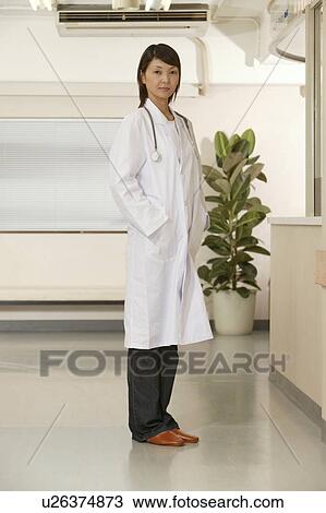 Stock Image - Portrait of female doctor, smiling. Fotosearch