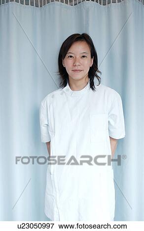 Stock Photo - Portrait of female massage therapist, smiling. Fotosearch