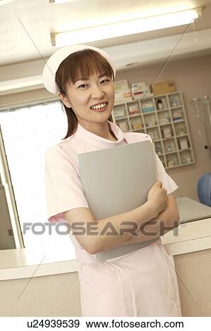 Stock Photo - Portrait of female nurse, smiling. Fotosearch