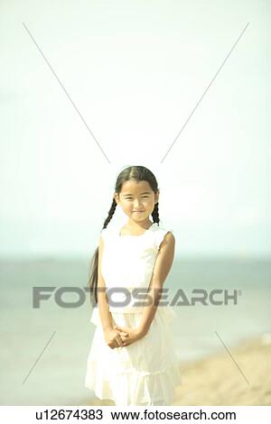 Stock Image - Portrait of girl at beach, Awaji city, Hyogo prefecture, Japan. Fotosearch