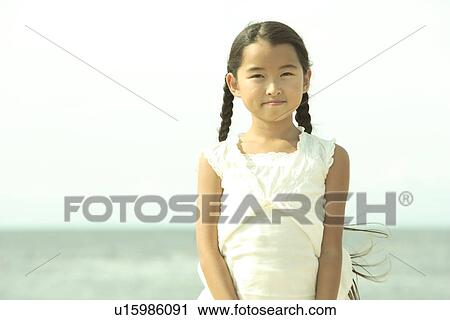 Stock Image - Portrait of girl at beach, Awaji city, Hyogo prefecture, Japan. Fotosearch