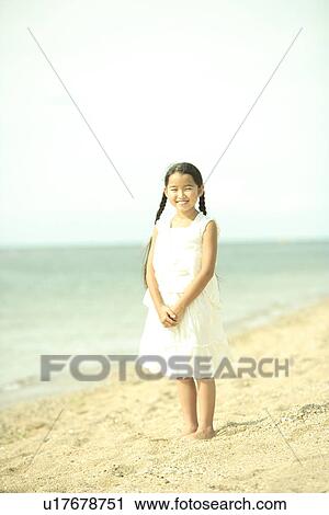 Stock Image - Portrait of girl at beach, Awaji city, Hyogo prefecture, Japan. Fotosearch